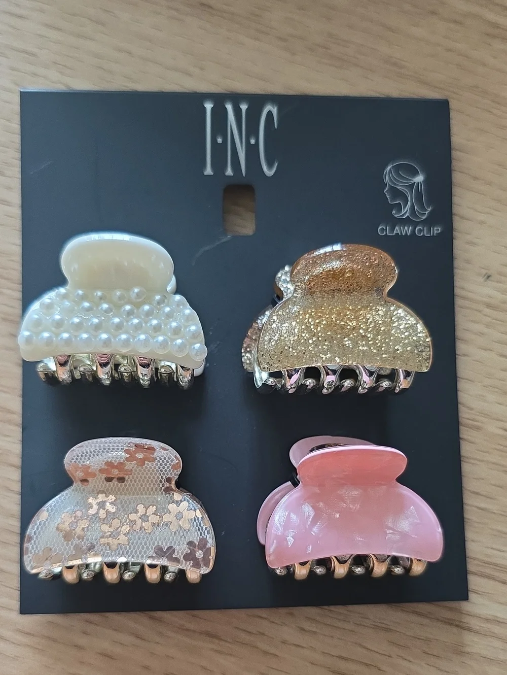 I.N.C. hair accessory set includes four distinct small acrylic claw clips.